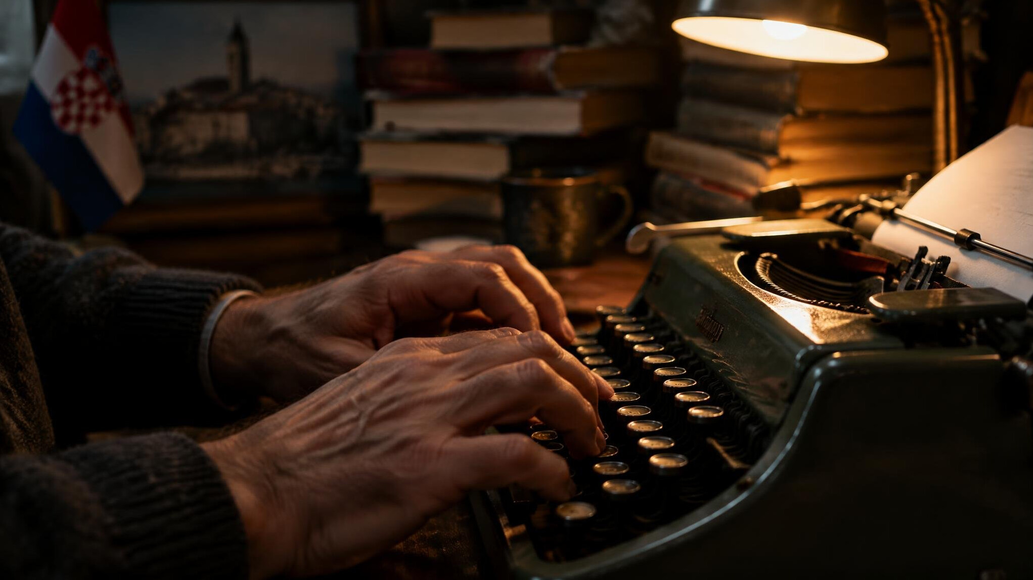 Close-up of hands typing on a vintage typewriter